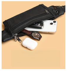 Black leather waist bag capacity reference with phone, watch, key and earbuds, angled top-down view