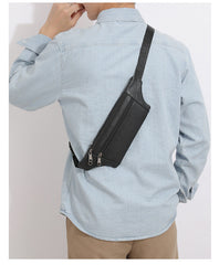 Black leather sling bag worn diagonally across the back, rear view showing complete strap and length