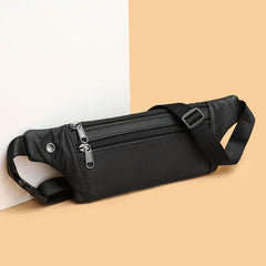 Black leather waist bag front zippers and strap adjuster buckle detail, three-quarter front angle